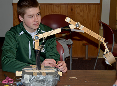 Youth making a robotic arm