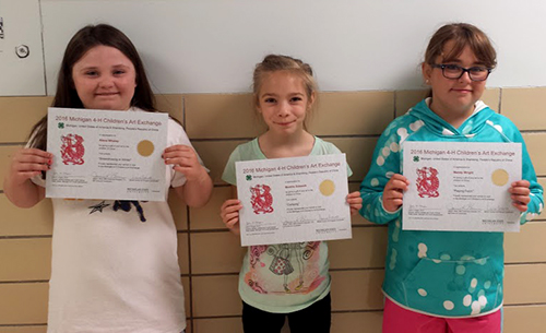 Elementary students with their certificates