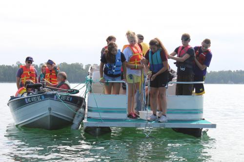 Great Lakes and Natural Resources Campers exploring the lake on a boat.