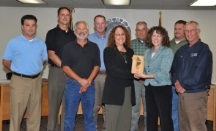 Emmet County commissioners accept the Member of the Year Award from the Michigan Recycling Coalition presented by the coalition’s executive director, Kerrin O’Brien (right center). DPW Director Elisa Seltzer is to her right.