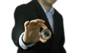 Business man holding a mini glass globe