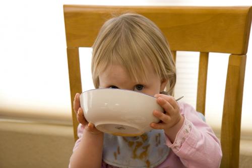 Toddler drinking from bowl