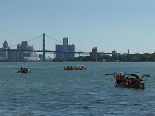 Canoes full of people on the Detroit River