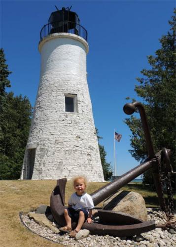 Child at a lighthouse image.